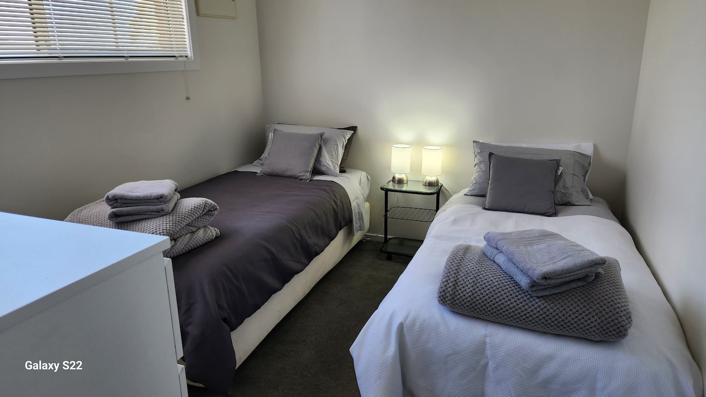 Two single beds in the second bedroom